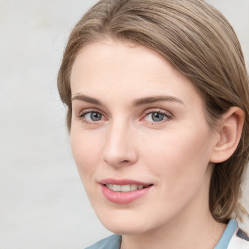 Joyful white young-adult female with medium  brown hair and blue eyes