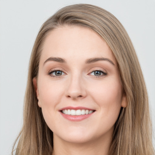 Joyful white young-adult female with long  brown hair and grey eyes