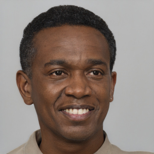 Joyful black young-adult male with short  black hair and brown eyes