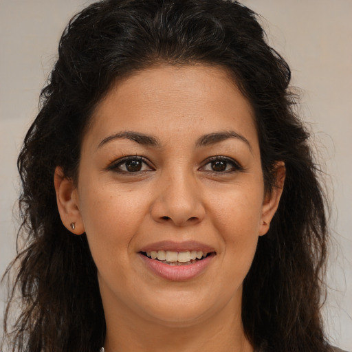 Joyful latino young-adult female with long  brown hair and brown eyes