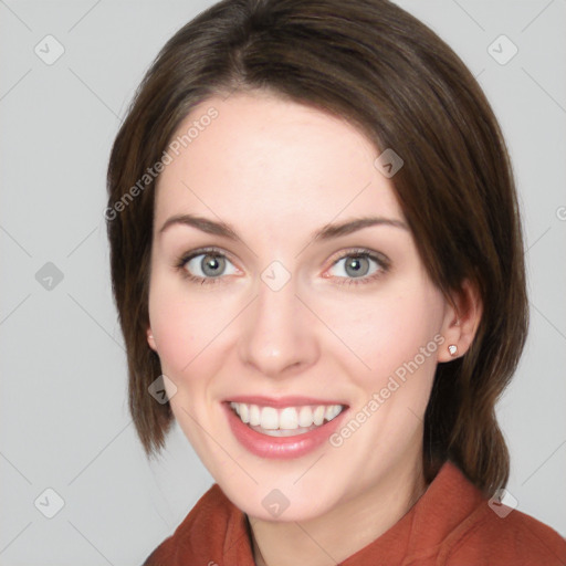 Joyful white young-adult female with medium  brown hair and green eyes