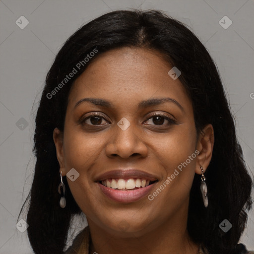 Joyful black young-adult female with long  brown hair and brown eyes