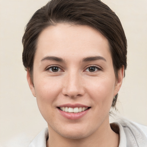 Joyful white young-adult female with short  brown hair and brown eyes