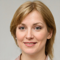 Joyful white adult female with medium  brown hair and grey eyes