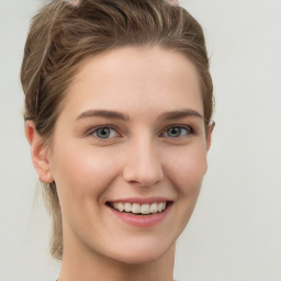 Joyful white young-adult female with medium  brown hair and green eyes