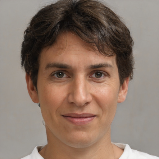 Joyful white adult male with short  brown hair and brown eyes