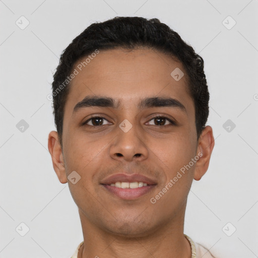 Joyful latino young-adult male with short  brown hair and brown eyes