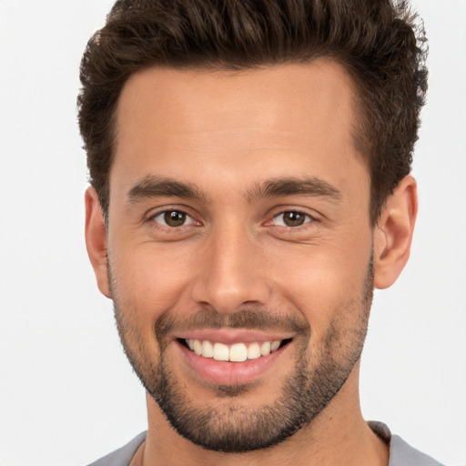 Joyful white young-adult male with short  brown hair and brown eyes