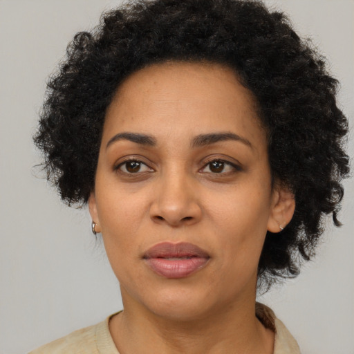 Joyful black adult female with short  brown hair and brown eyes