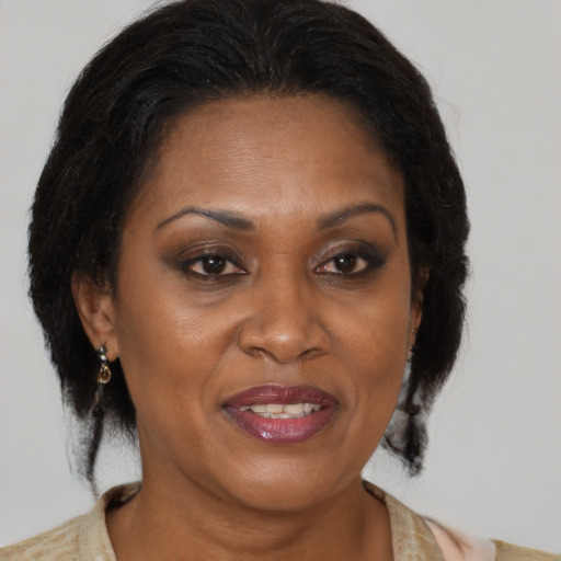 Joyful black adult female with medium  brown hair and brown eyes
