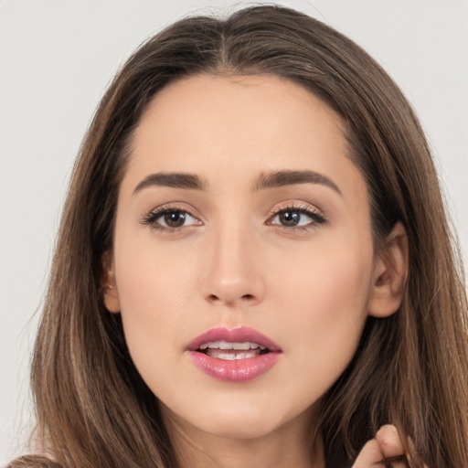 Joyful white young-adult female with long  brown hair and brown eyes