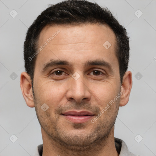 Joyful white adult male with short  brown hair and brown eyes