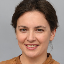 Joyful white adult female with medium  brown hair and brown eyes