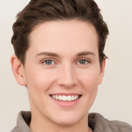 Joyful white young-adult female with short  brown hair and grey eyes