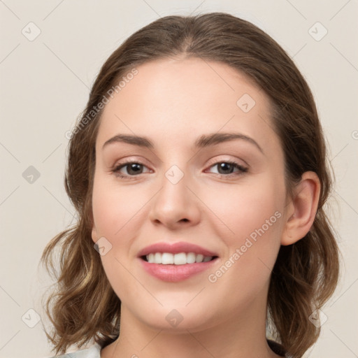 Joyful white young-adult female with medium  brown hair and green eyes