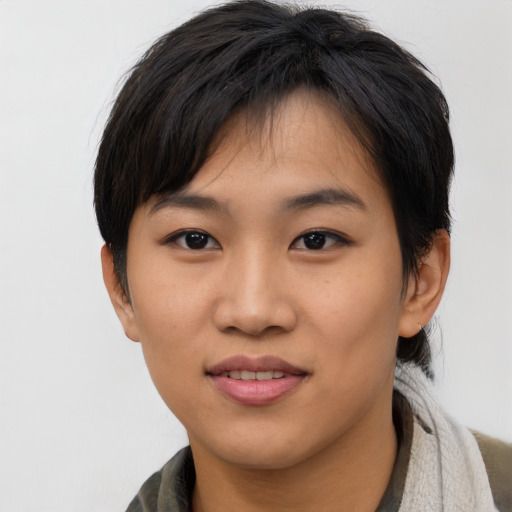 Joyful asian young-adult female with short  brown hair and brown eyes