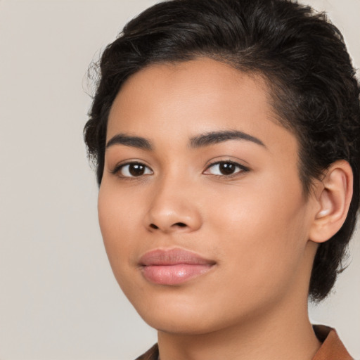 Joyful latino young-adult female with short  brown hair and brown eyes