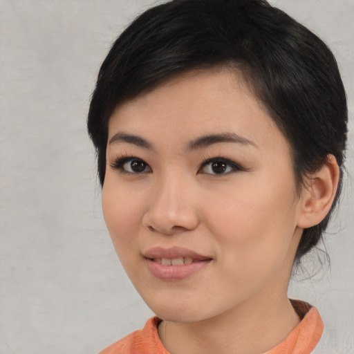Joyful asian young-adult female with medium  black hair and brown eyes