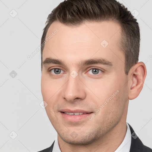 Joyful white young-adult male with short  brown hair and brown eyes