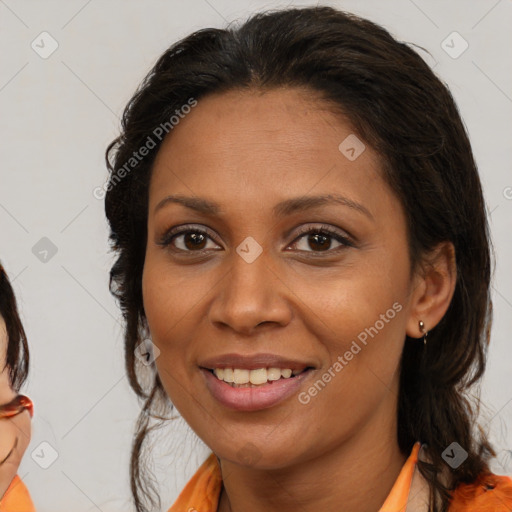Joyful latino adult female with medium  brown hair and brown eyes