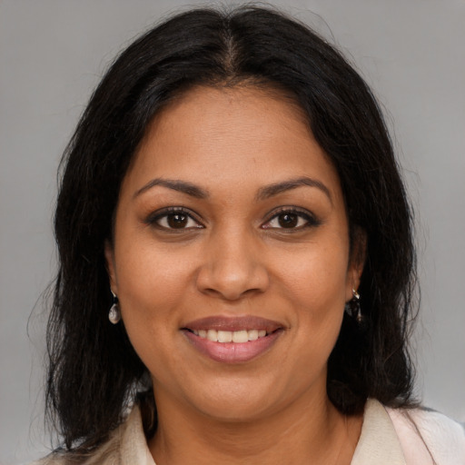 Joyful black young-adult female with medium  brown hair and brown eyes