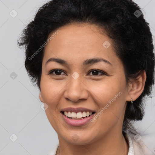 Joyful latino adult female with medium  brown hair and brown eyes