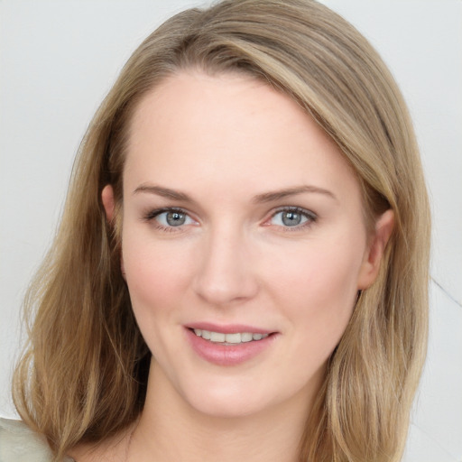 Joyful white young-adult female with long  brown hair and blue eyes