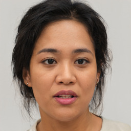 Joyful asian young-adult female with medium  brown hair and brown eyes