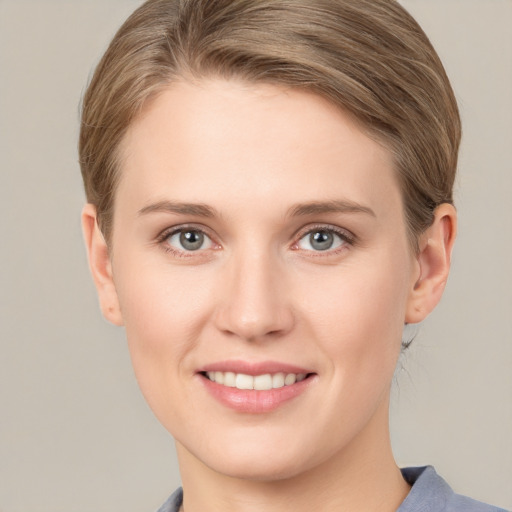 Joyful white young-adult female with medium  brown hair and blue eyes