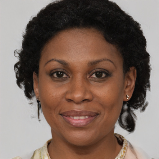 Joyful black young-adult female with medium  brown hair and brown eyes