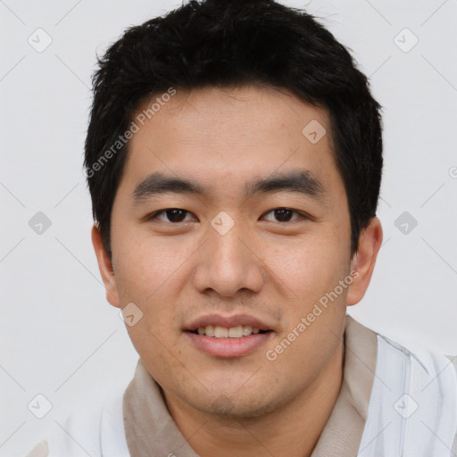 Joyful asian young-adult male with short  black hair and brown eyes