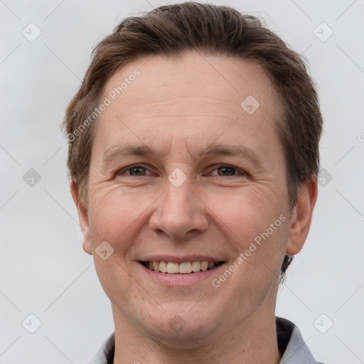 Joyful white adult male with short  brown hair and grey eyes