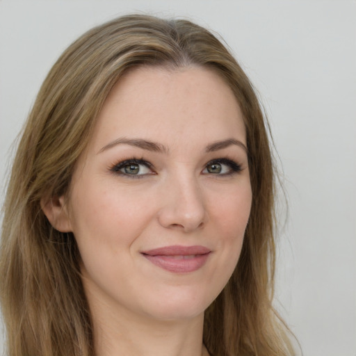 Joyful white young-adult female with long  brown hair and green eyes