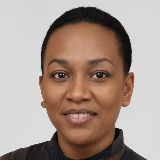 Joyful latino young-adult female with short  black hair and brown eyes