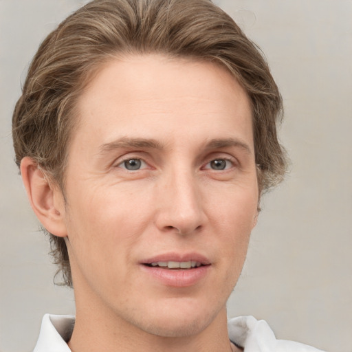 Joyful white adult male with medium  brown hair and grey eyes