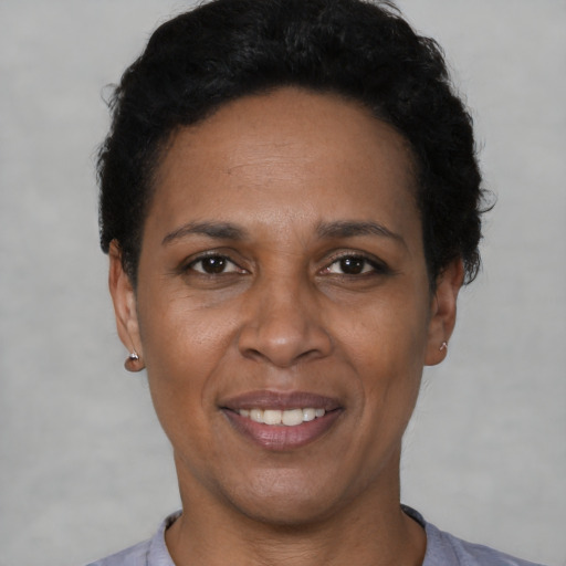 Joyful latino adult female with short  black hair and brown eyes