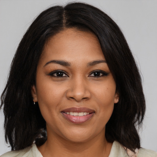 Joyful latino young-adult female with medium  black hair and brown eyes