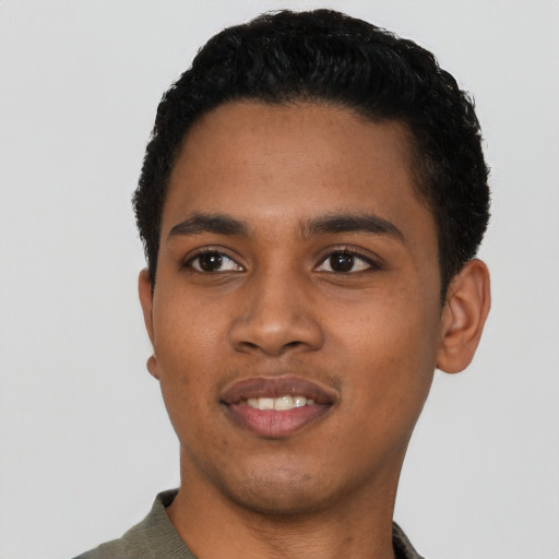 Joyful black young-adult male with short  black hair and brown eyes