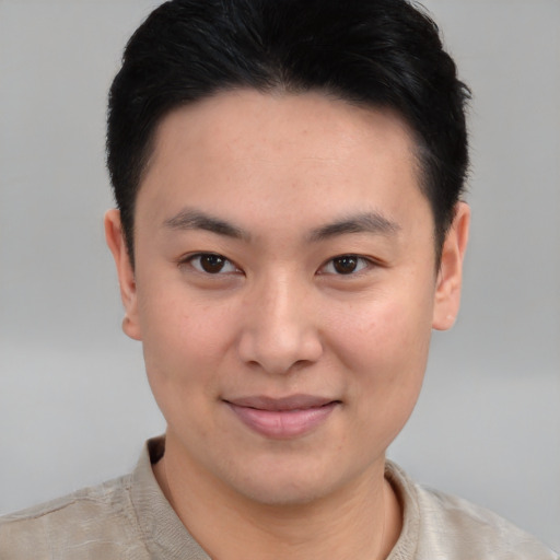 Joyful asian young-adult male with short  brown hair and brown eyes