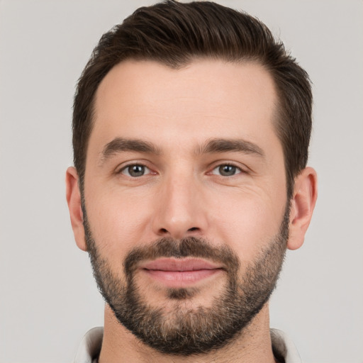 Joyful white young-adult male with short  brown hair and brown eyes