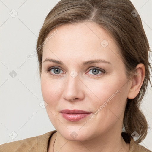 Joyful white young-adult female with medium  brown hair and blue eyes