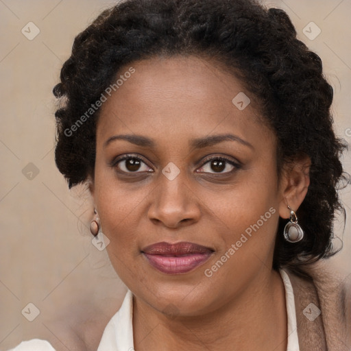 Joyful black young-adult female with long  brown hair and brown eyes