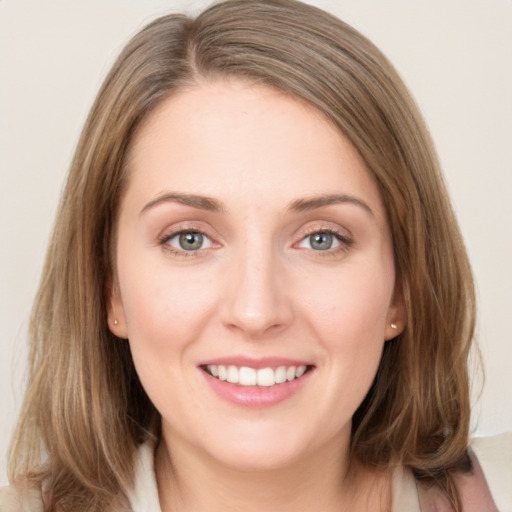 Joyful white young-adult female with medium  brown hair and blue eyes