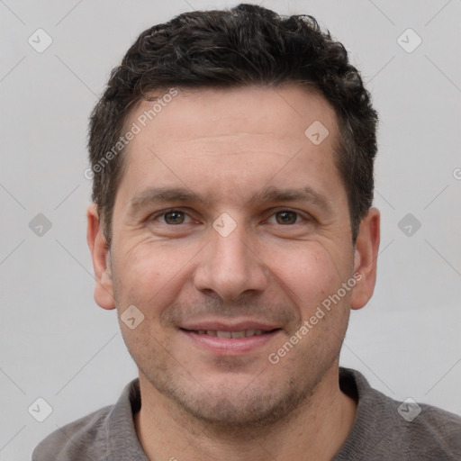 Joyful white adult male with short  brown hair and grey eyes