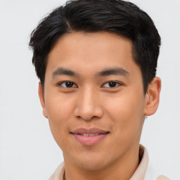 Joyful asian young-adult male with short  brown hair and brown eyes