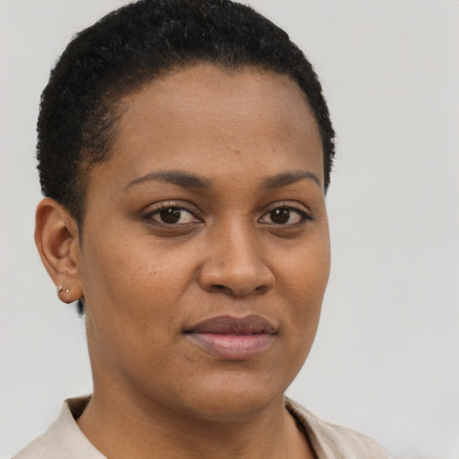 Joyful black young-adult female with short  brown hair and brown eyes
