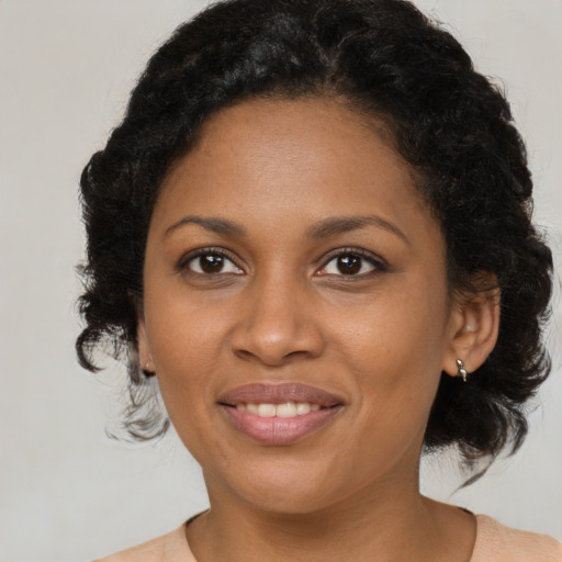 Joyful black young-adult female with medium  brown hair and brown eyes