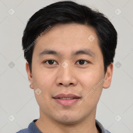 Joyful asian young-adult male with short  black hair and brown eyes