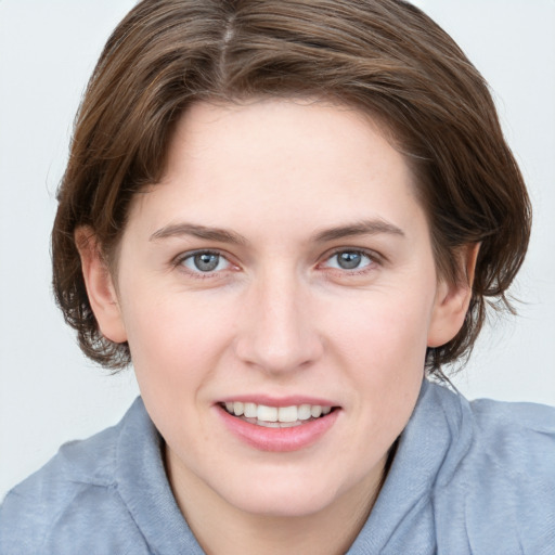 Joyful white young-adult female with medium  brown hair and blue eyes