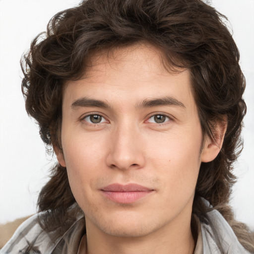 Joyful white young-adult male with medium  brown hair and brown eyes